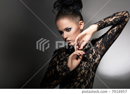Femininity. Attractive Stylized Woman in Black Dress with Bow-knot. Neatness Femininity. Attractive Stylized Woman in Black Dress with Bow-knot. Neatness 7018957