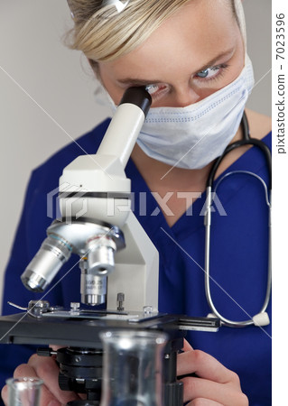 Female Scientist or Woman Doctor Using Microscope in a Laborator 7023596