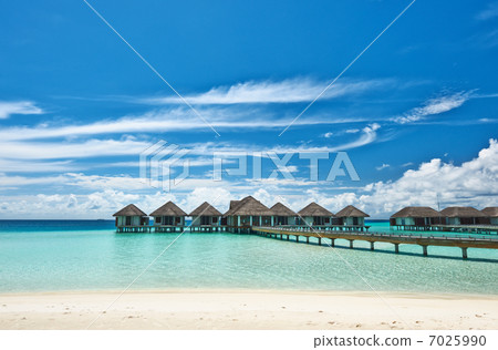 Beautiful beach with water bungalows 7025990