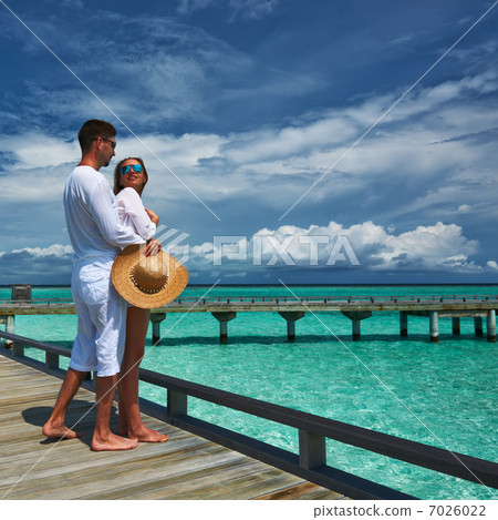 Couple on a beach jetty at Maldives 7026022