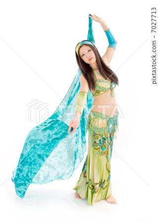 A female dancer who dances belly dance with a vivid silk veil 7027713