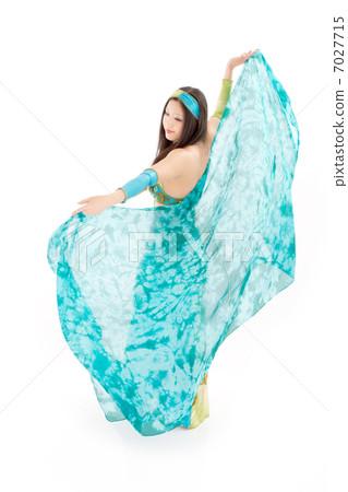 A woman dancing belly dance with a cool silk veil 7027715