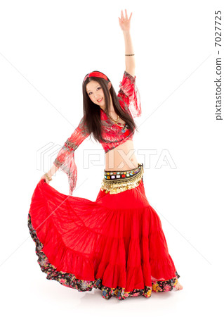 A passionate woman dancing belly dance with a crimson sexy costume A passionate woman dancing belly dance with a crimson sexy costume 7027725