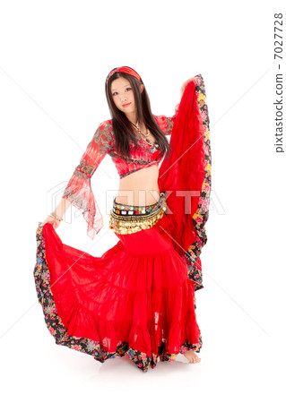 A young lady dancing belly dance with a sexy and passionate red costume 7027728