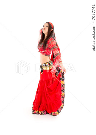 A young woman who wears a sexy pose wearing a crimson bellydance costume A young woman who wears a sexy pose wearing a crimson bellydance costume 7027741