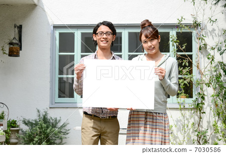 A couple with a white board 7030586