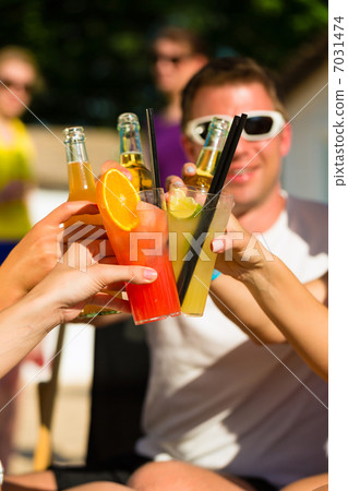People at beach drinking having a party 7031474