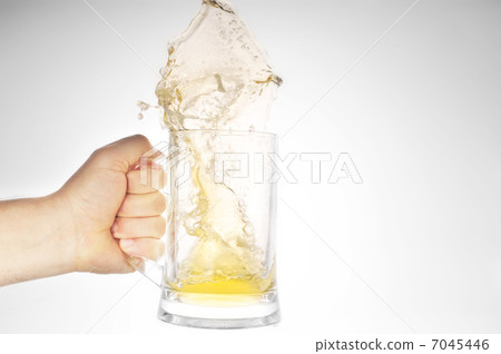 Hand holding mug with splashing beer 7045446