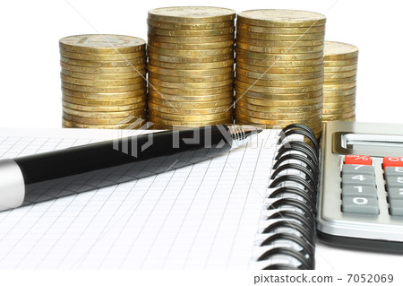 Stationery with stack of coins . 7052069