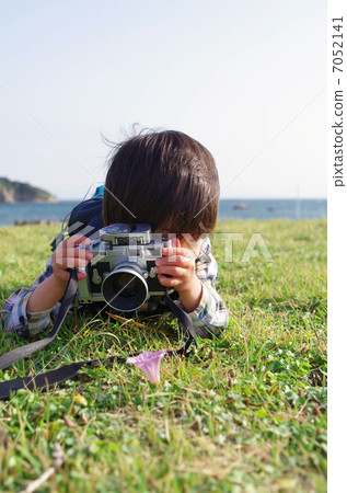 A small photographer shooting with a rangefinder camera 7052141