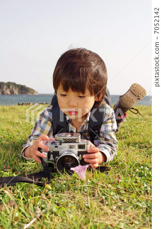 A small photographer shooting with a rangefinder camera 7052142
