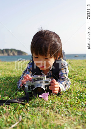 A small photographer shooting with a rangefinder camera 7052143