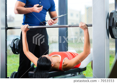 woman and Personal Trainer in gym woman and Personal Trainer in gym 7053553