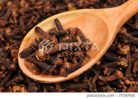Cloves (spice) and wooden spoon close-up food background Cloves (spice) and wooden spoon close-up food background 7056988