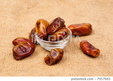 dried dates on glass bowl on canvas background 7057083