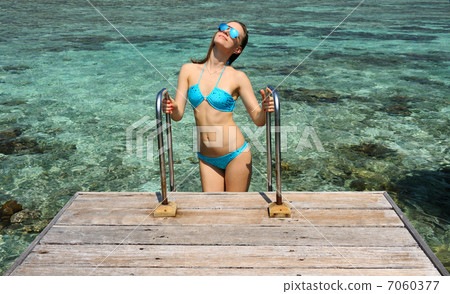 Woman on a beach jetty at Maldives Woman on a beach jetty at Maldives 7060377