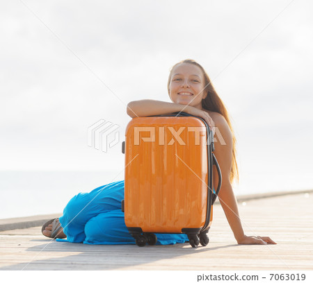 Young woman sitting on wooden pier Young woman sitting on wooden pier 7063019