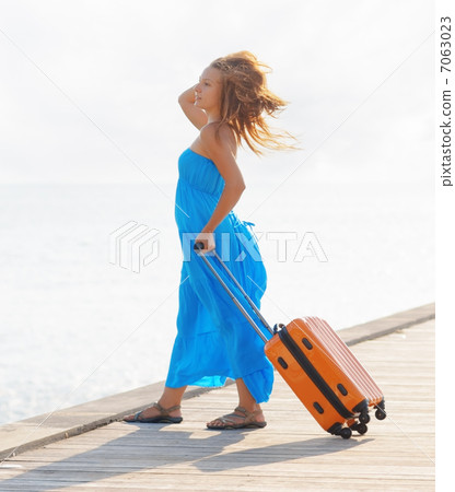 Young woman with suitcase on the pier Young woman with suitcase on the pier 7063023