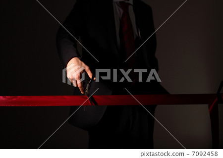 Businessman with scissors cuting a red ribbon 7092458