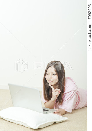 A woman who operates a personal computer in a room A woman who operates a personal computer in a room 7092608
