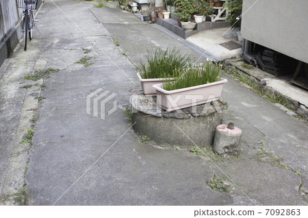 Old well in the downtown alley 7092863