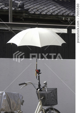 A parasol attached to the handle of the bicycle A parasol attached to the handle of the bicycle 7093580