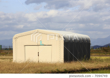 A large tent warehouse assembled in the field A large tent warehouse assembled in the field 7094749