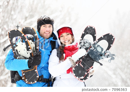 Winter couple outdoors on snowshoes Winter couple outdoors on snowshoes 7096363