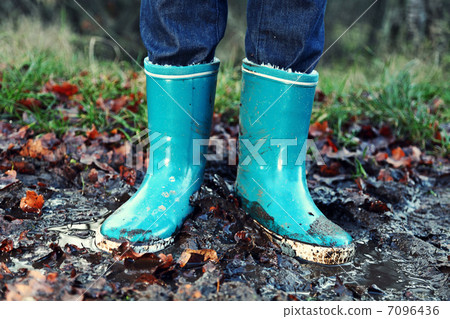 Fall / Autumn concept - Rain boots in mud puddle Fall / Autumn concept - Rain boots in mud puddle 7096436