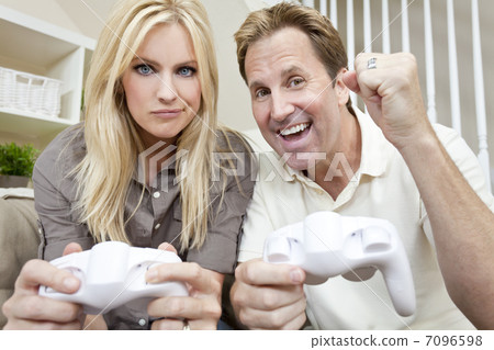 Married Couple Having Fun Playing Video Console Game 7096598