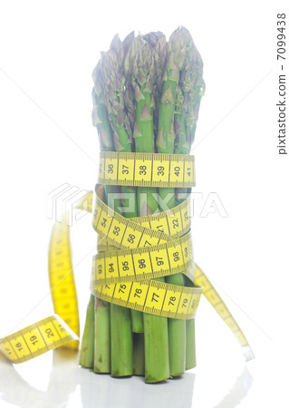 bunch of asparagus tied with measuring tape isolated on white bunch of asparagus tied with measuring tape isolated on white 7099438