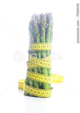bunch of asparagus tied with measuring tape isolated on white bunch of asparagus tied with measuring tape isolated on white 7099448
