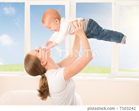 happy family. Mother throws up baby, playing 7103242
