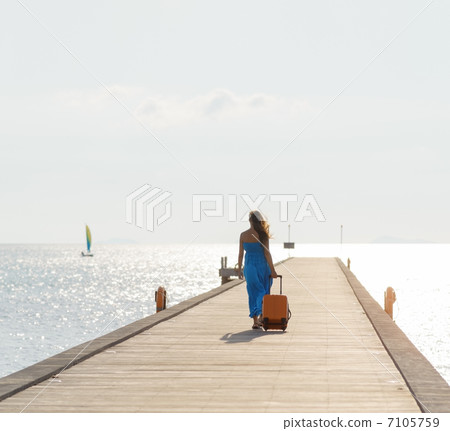 Young woman walking on wooden pier Young woman walking on wooden pier 7105759
