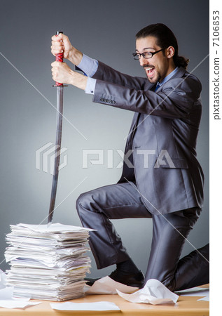 Businessman cutting the pile of paper Businessman cutting the pile of paper 7106853