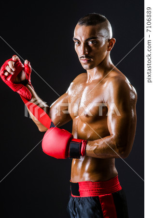 Boxer with red gloves in dark room Boxer with red gloves in dark room 7106889