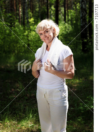 Portrait of an elderly woman in sportswear with a towel Portrait of an elderly woman in sportswear with a towel 7107713