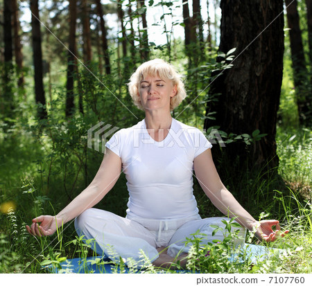 An elderly woman practices yoga An elderly woman practices yoga 7107760