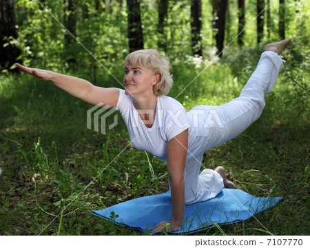 An elderly woman practices yoga An elderly woman practices yoga 7107770