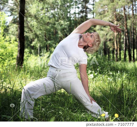 An elderly woman practices yoga An elderly woman practices yoga 7107777