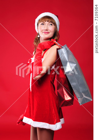 young girl dressed as Santa Claus 7109364