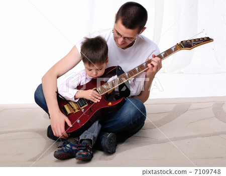 young father teaches his young son young father teaches his young son 7109748
