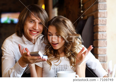 Young couple with engagement ring in a restaurant Young couple with engagement ring in a restaurant 7109749