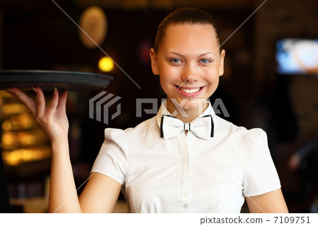 Portrait of young waitress holding a tray 7109751