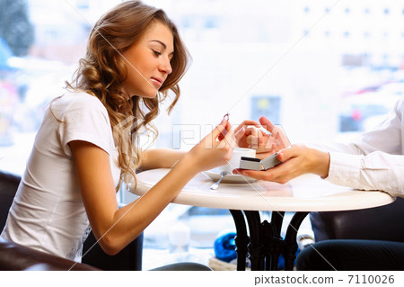 Young couple with engagement ring in a restaurant Young couple with engagement ring in a restaurant 7110026