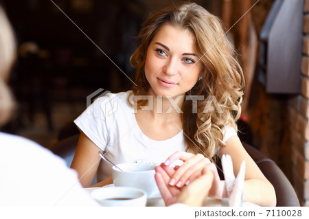 Young pretty woman sitting in restaurant Young pretty woman sitting in restaurant 7110028
