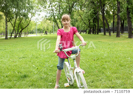 Girl with a bike in the park Girl with a bike in the park 7110759