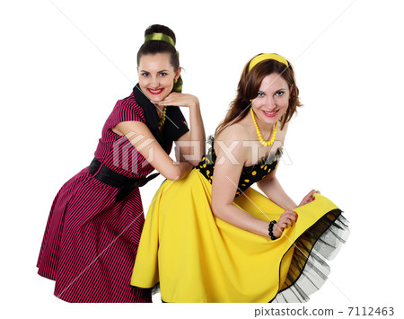 two young woman in bright colour dresses two young woman in bright colour dresses 7112463