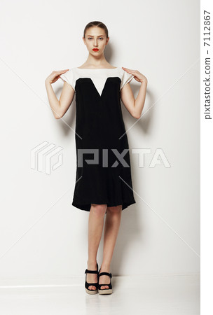 Minimalism. Stylish Woman Fashion Model in Comfy Contrast Dress. Comfort Minimalism. Stylish Woman Fashion Model in Comfy Contrast Dress. Comfort 7112867