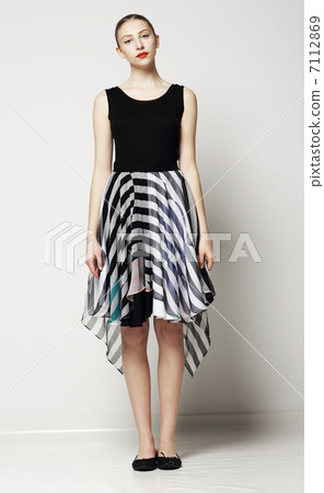 Full Length of Modish Woman in Strippy Dress. Springtime Workday Collection Full Length of Modish Woman in Strippy Dress. Springtime Workday Collection 7112869